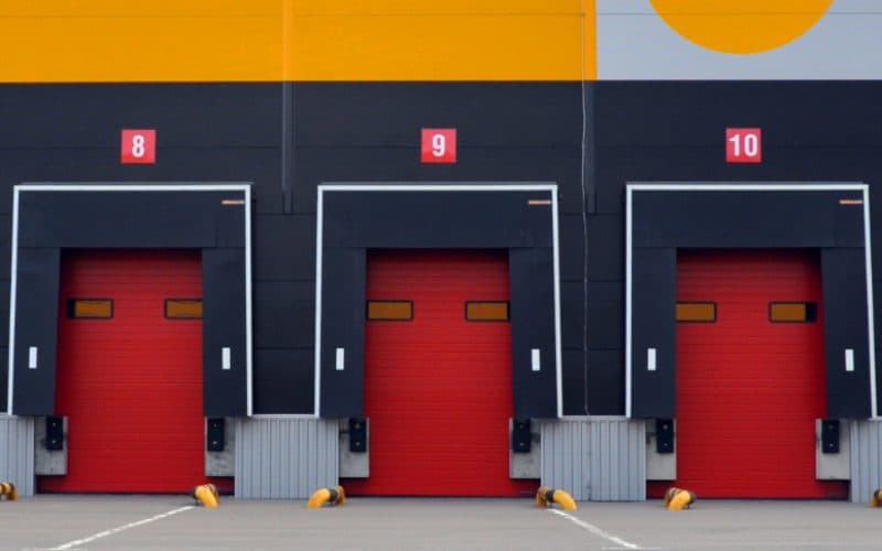 Modern logistic warehouse. A row of loading pads with gates. Industry